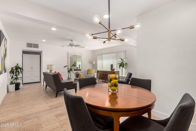 dining space with light wood finished floors, visible vents, baseboards, recessed lighting, and ceiling fan with notable chandelier