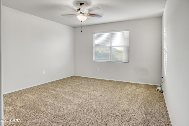 unfurnished room featuring ceiling fan and carpet