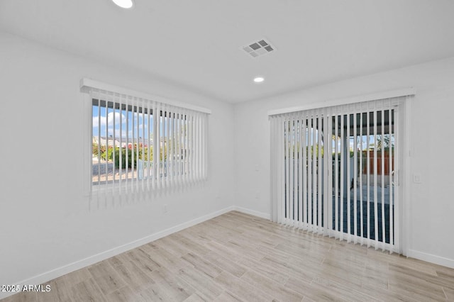 unfurnished room with plenty of natural light and light wood-type flooring