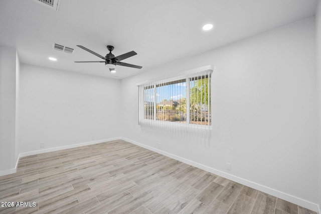 empty room featuring ceiling fan and light hardwood / wood-style flooring