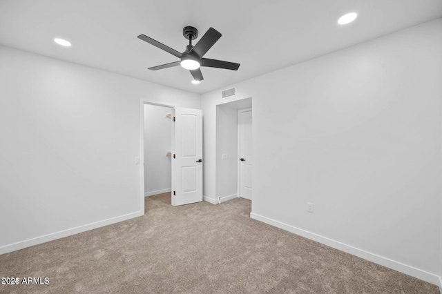 unfurnished bedroom with ceiling fan and light colored carpet