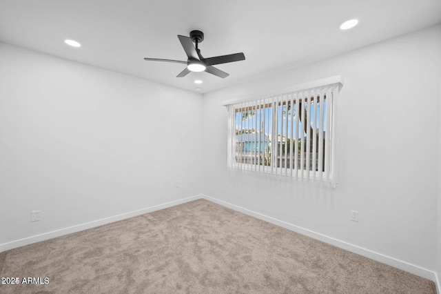 spare room with carpet flooring and ceiling fan