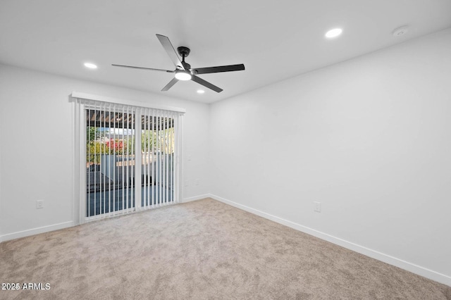 spare room featuring ceiling fan and carpet floors