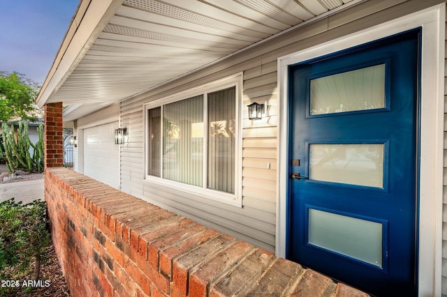 view of exterior entry featuring a garage