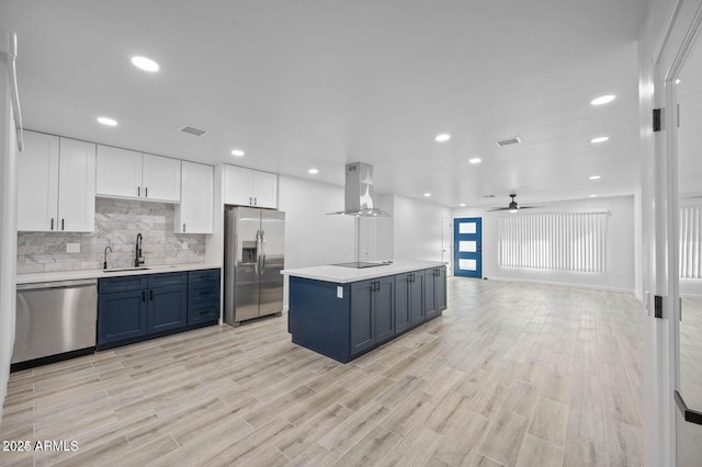 kitchen featuring white cabinets, sink, stainless steel appliances, and exhaust hood