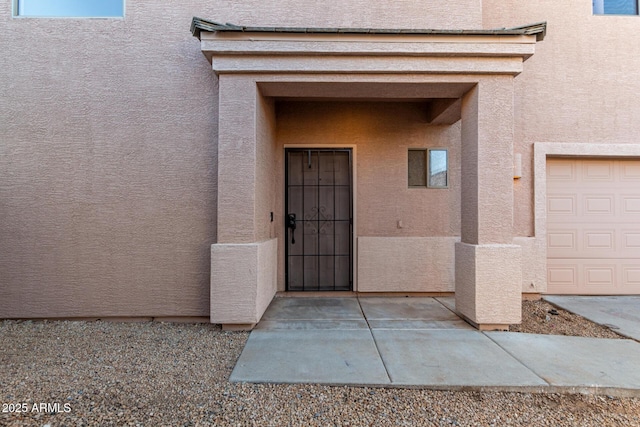 doorway to property featuring a garage