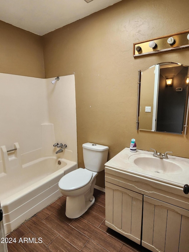 full bathroom with vanity, wood-type flooring,  shower combination, and toilet