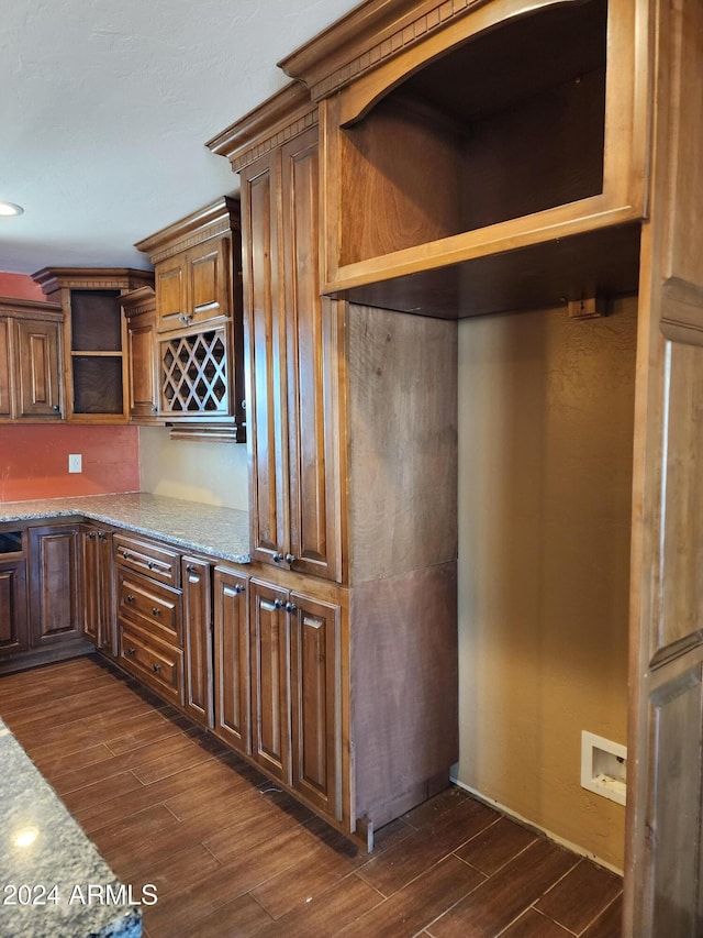 kitchen featuring dark hardwood / wood-style flooring and light stone countertops