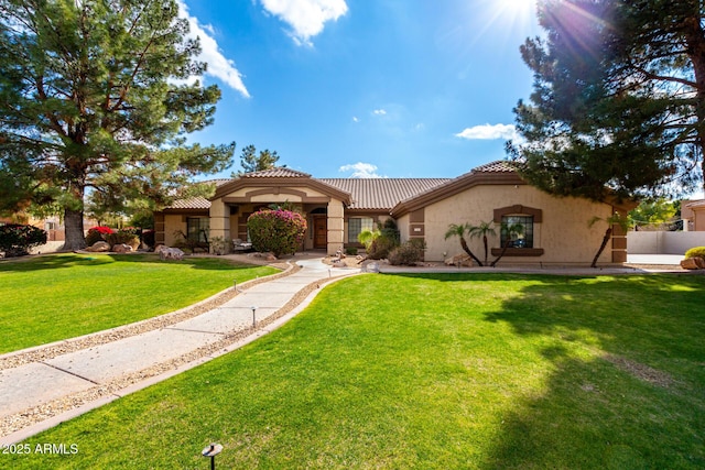 mediterranean / spanish house featuring a front lawn