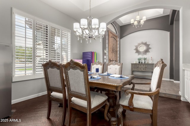 dining room featuring an inviting chandelier and dark hardwood / wood-style floors