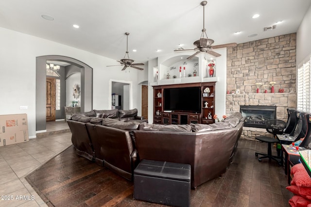 living room featuring a healthy amount of sunlight, hardwood / wood-style floors, a fireplace, and ceiling fan