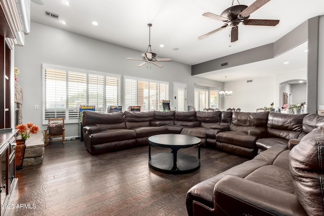 living room with ceiling fan with notable chandelier