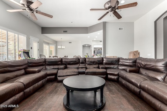 living room featuring ceiling fan with notable chandelier and dark hardwood / wood-style floors