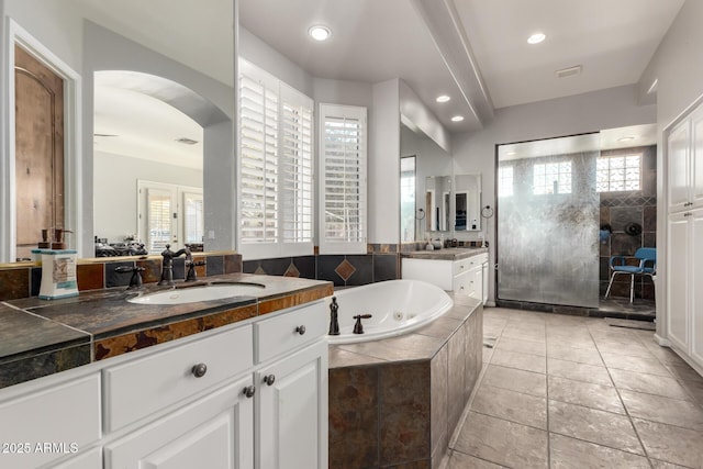 bathroom with vanity, tile patterned flooring, and shower with separate bathtub