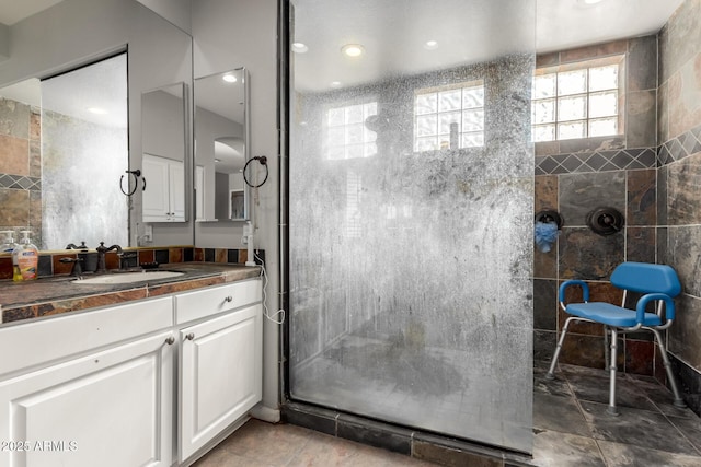 bathroom featuring vanity and a tile shower