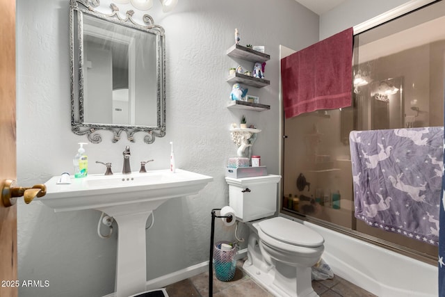 bathroom featuring tile patterned floors, shower / bath combination with glass door, and toilet