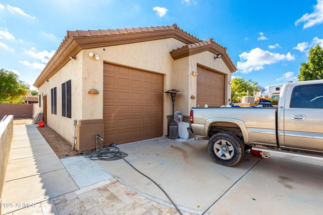 view of side of property with a garage and an outdoor structure