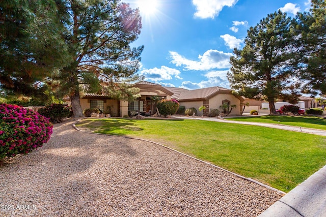 mediterranean / spanish-style house featuring a front lawn