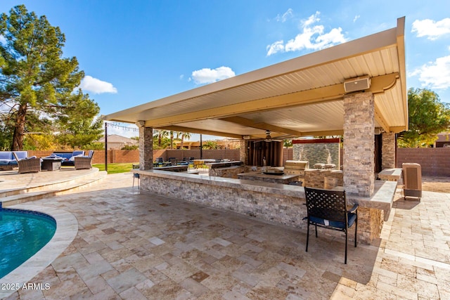 view of patio with exterior bar, area for grilling, outdoor lounge area, and a fenced in pool