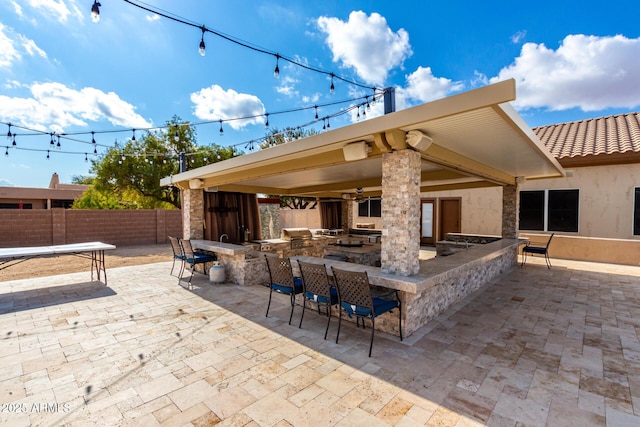 view of patio / terrace with exterior bar and exterior kitchen