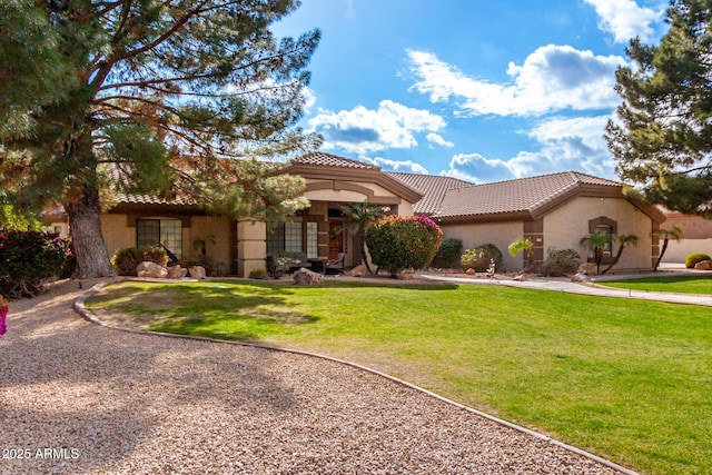 mediterranean / spanish-style house with a front yard