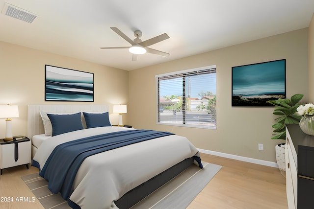 bedroom with ceiling fan and light hardwood / wood-style flooring