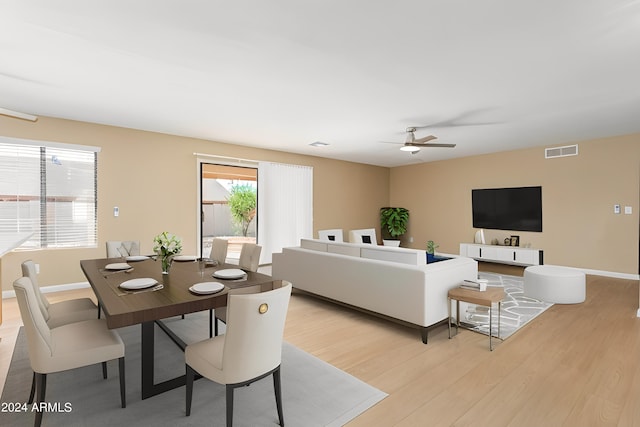 living room featuring light wood-type flooring and ceiling fan