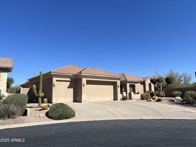 prairie-style home with stucco siding, a tiled roof, concrete driveway, and a garage