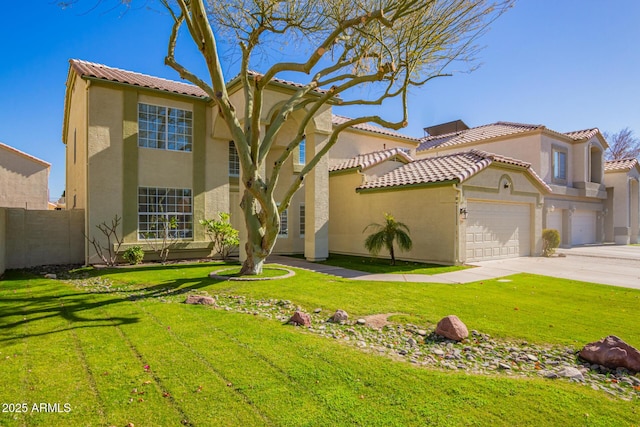 mediterranean / spanish home with a front lawn and a garage