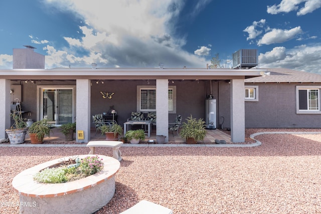 1445 W Wood Dr, Phoenix, AZ 85029 - back of property with stucco siding, a patio, central AC unit, and water heater