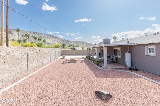 1445 W Wood Dr, Phoenix, AZ 85029 - fenced backyard with gas water heater, a mountain view, and a patio area