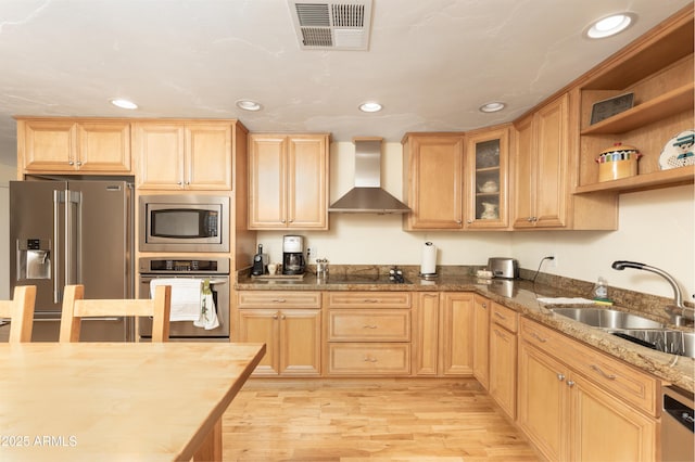 1445 W Wood Dr, Phoenix, AZ 85029 - kitchen with appliances with stainless steel finishes, wall chimney range hood, a sink, light brown cabinetry, and light wood-style floors