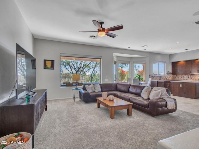 carpeted living room with plenty of natural light and ceiling fan