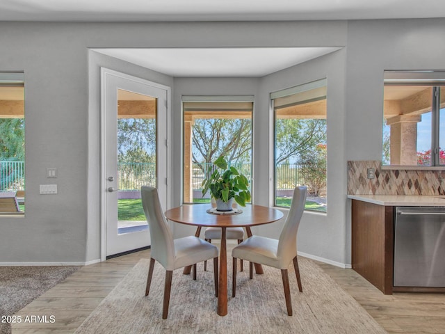 dining space with light hardwood / wood-style floors