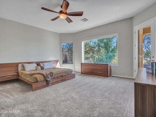 carpeted living room with ceiling fan