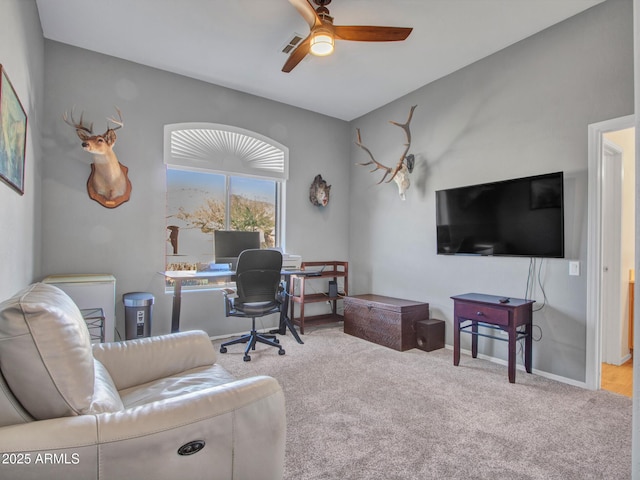 office space featuring light carpet and ceiling fan