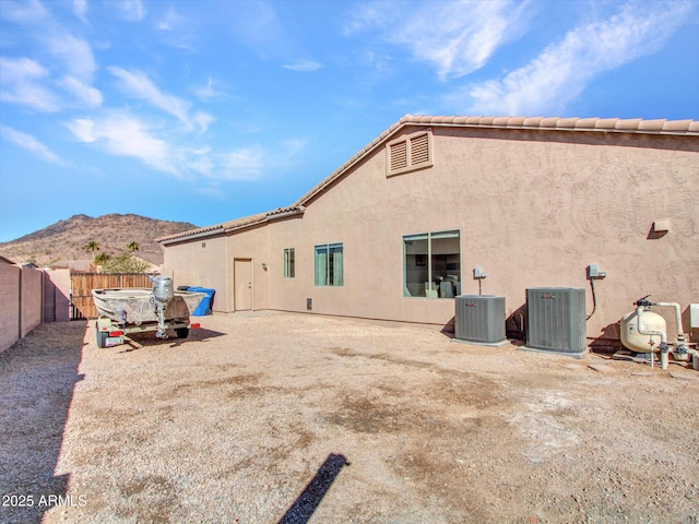 rear view of house with a mountain view and central air condition unit