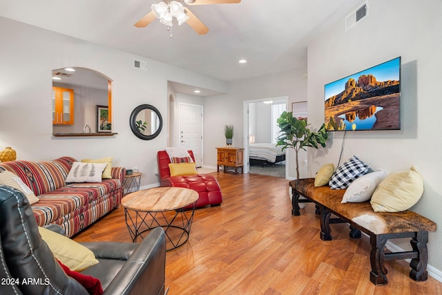 living room featuring ceiling fan and light wood-type flooring