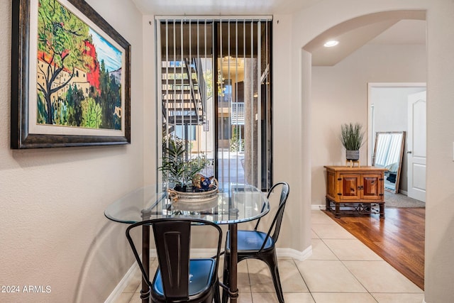 tiled dining space with a healthy amount of sunlight