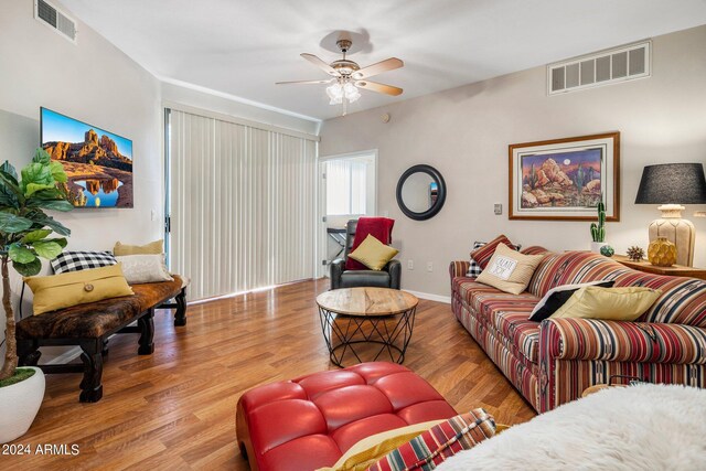 living room featuring ceiling fan and hardwood / wood-style flooring