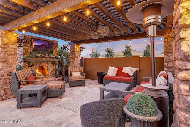 patio terrace at dusk featuring an outdoor living space with a fireplace and a pergola