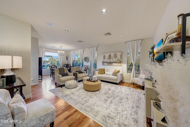 living room featuring a notable chandelier and hardwood / wood-style flooring