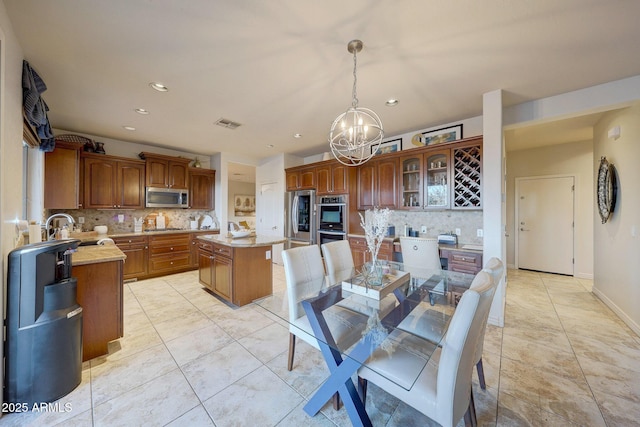 tiled dining area with an inviting chandelier