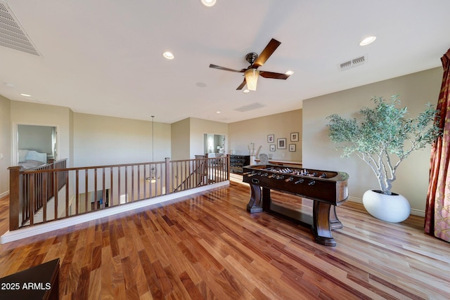 game room featuring light hardwood / wood-style floors and ceiling fan