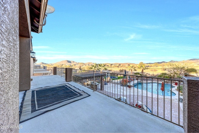 balcony featuring a mountain view and a patio