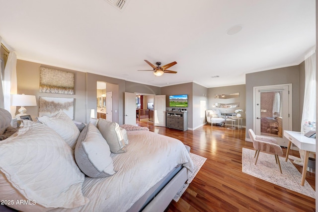 bedroom with hardwood / wood-style flooring, crown molding, and ceiling fan