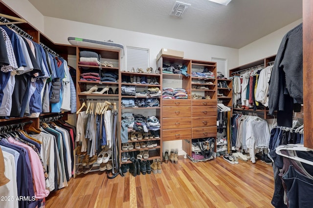 spacious closet with hardwood / wood-style floors