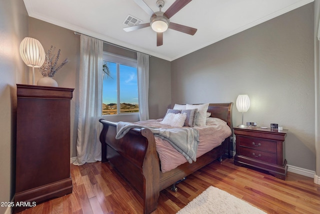 bedroom with crown molding, wood-type flooring, and ceiling fan