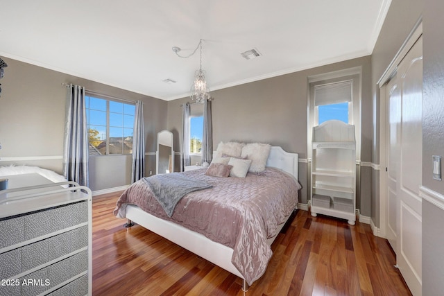 bedroom featuring hardwood / wood-style flooring and ornamental molding