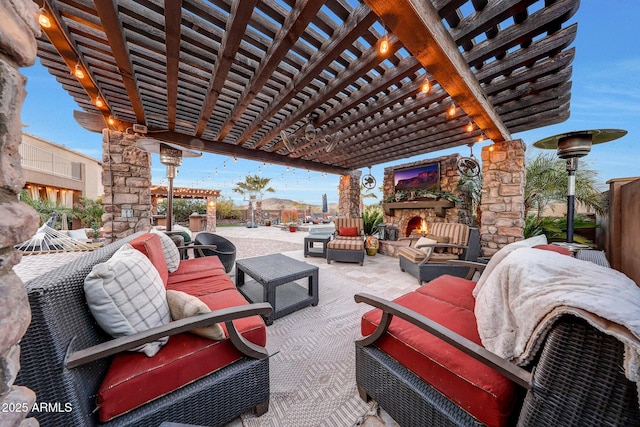 view of patio / terrace with an outdoor living space with a fireplace and a pergola